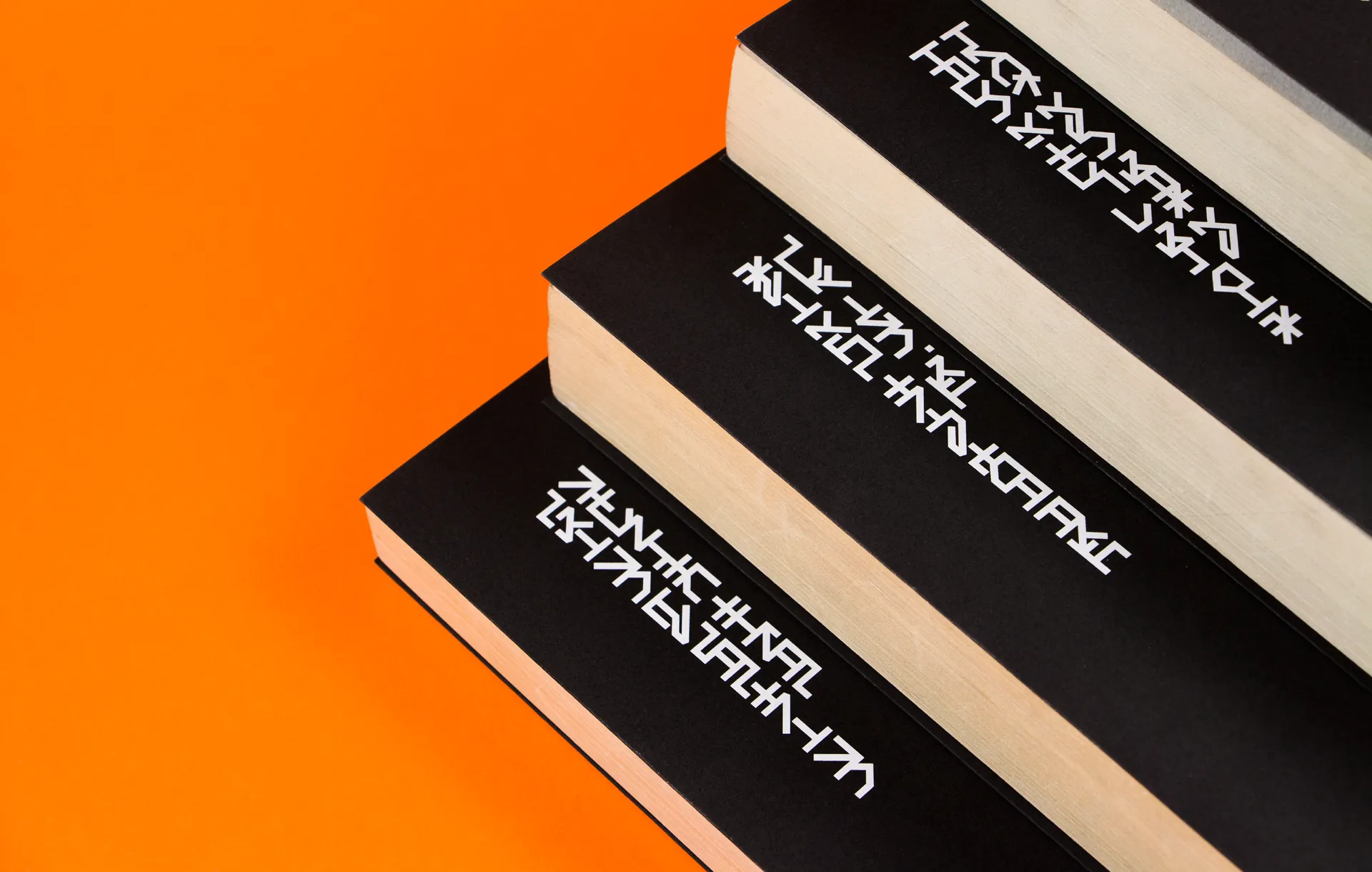 Black and white book cover closeup on a bright orange background